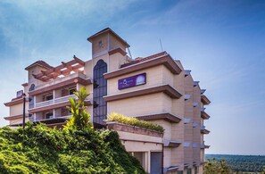 Experience the unique architecture of The Queen Hotel, set amidst lush surroundings.