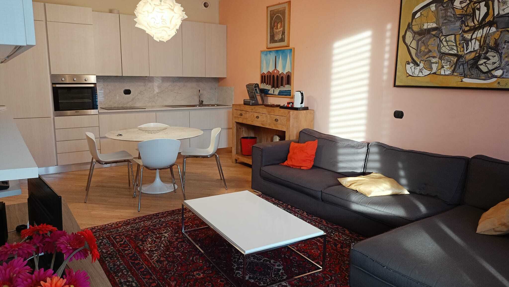 A modern apartment with a kitchen, dining area, and living room.