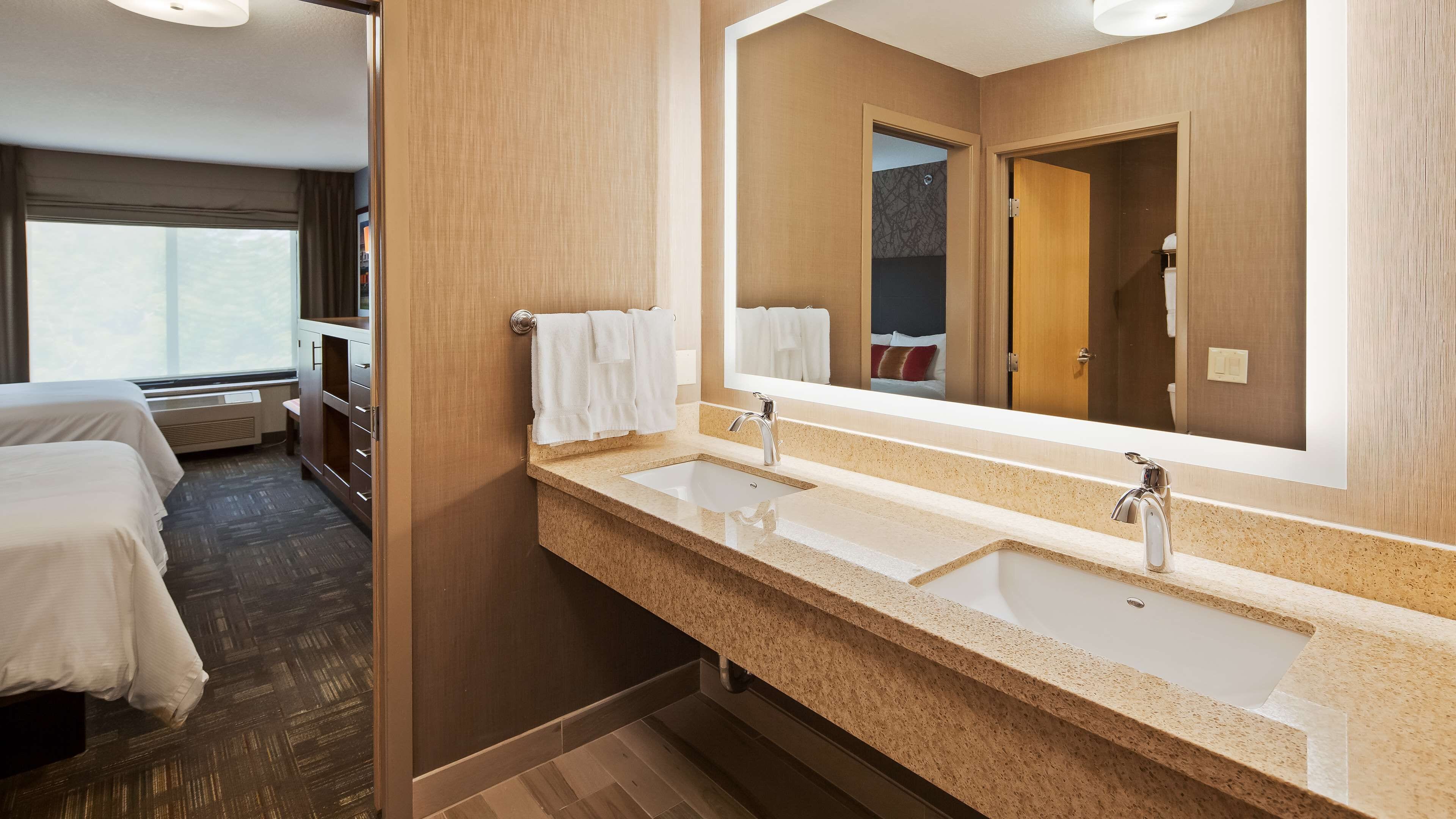 suite, 2 queen beds, non smoking (living room) | bathroom | combined shower/bathtub, free toiletries, hair dryer, towels