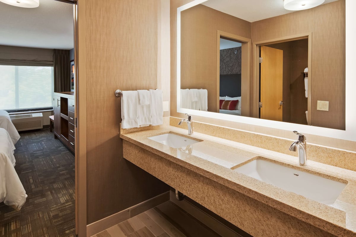 suite, 2 queen beds, non smoking (living room) | bathroom | combined shower/bathtub, free toiletries, hair dryer, towels