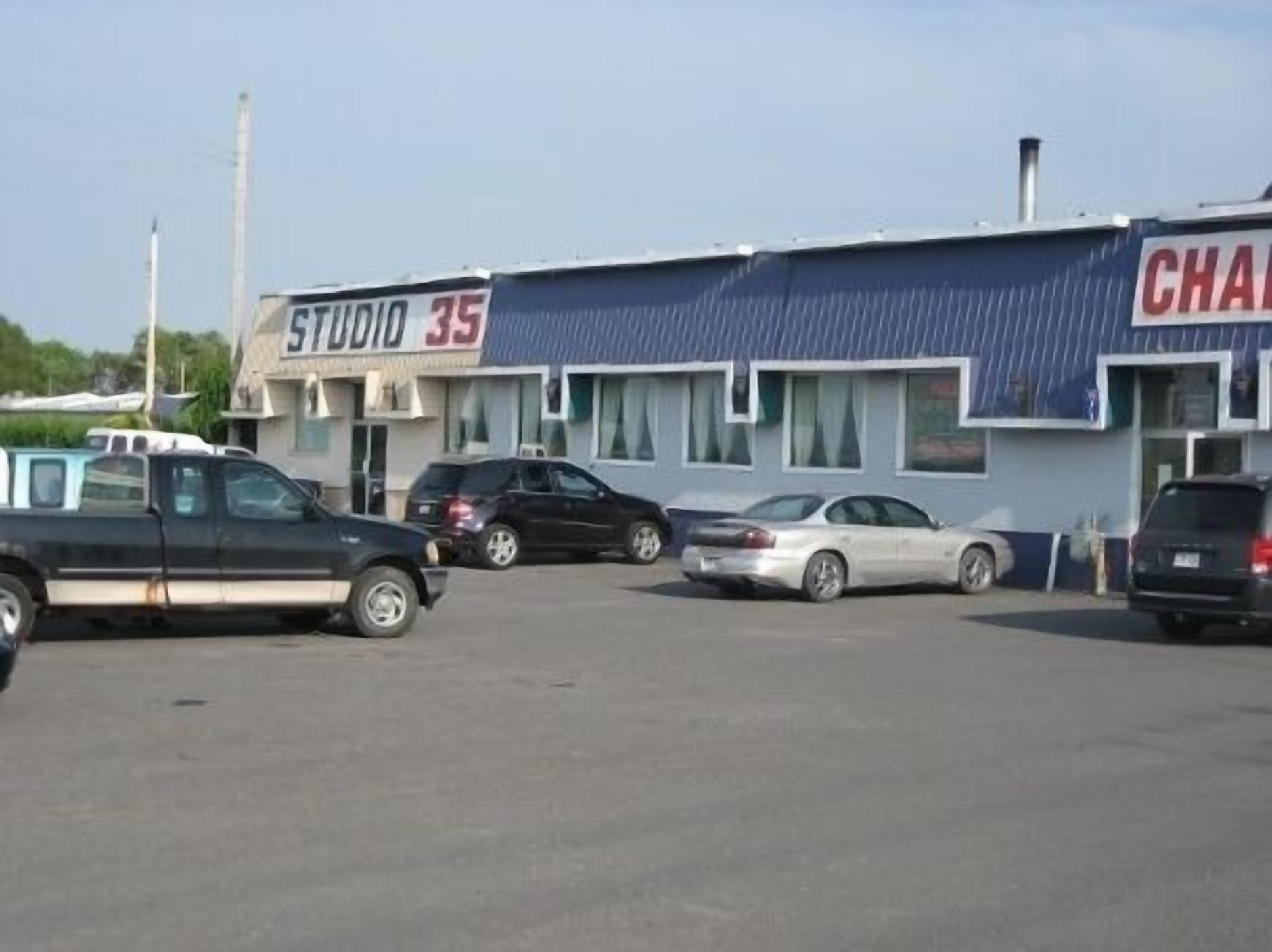 A parking lot with a building labeled "STUDIO 35" and another building with "CHAM" partially visible.