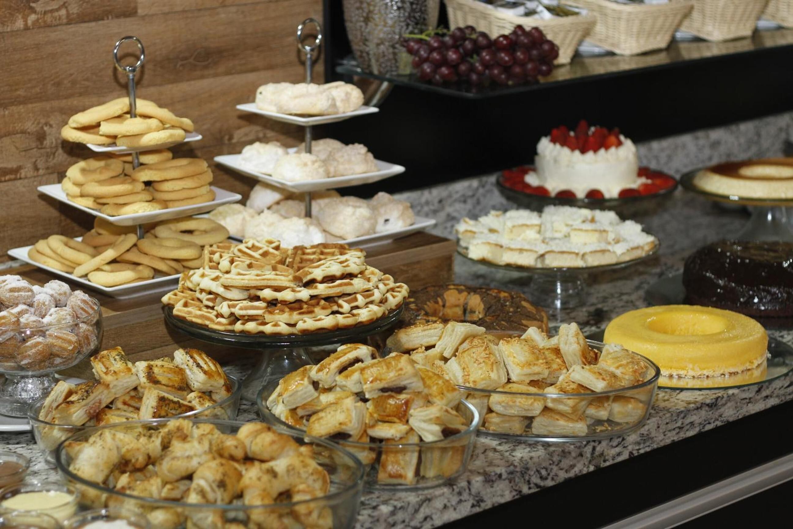 A buffet with various pastries and desserts.