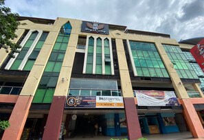 A hotel with a prominent sign for 'Royal City Hotel' and a 'Storytel' advertisement. - Super OYO 89847 Switz Paradise Hotel (Kota Kinabalu)