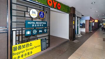 A hotel reception area with a 'HOTEL RECEPTION' sign, a 'BAGGAGE STORAGE SERVICE' sign, and a 'STORYTEL' sign.