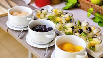 A table with various fruit bowls and cups, likely a fruit salad or snack setup.