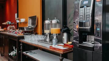 A coffee station with a coffee machine, milk frother, and two milk dispensers.