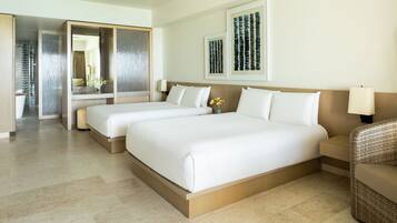 A hotel room with two beds, a large mirror, and artwork on the wall.