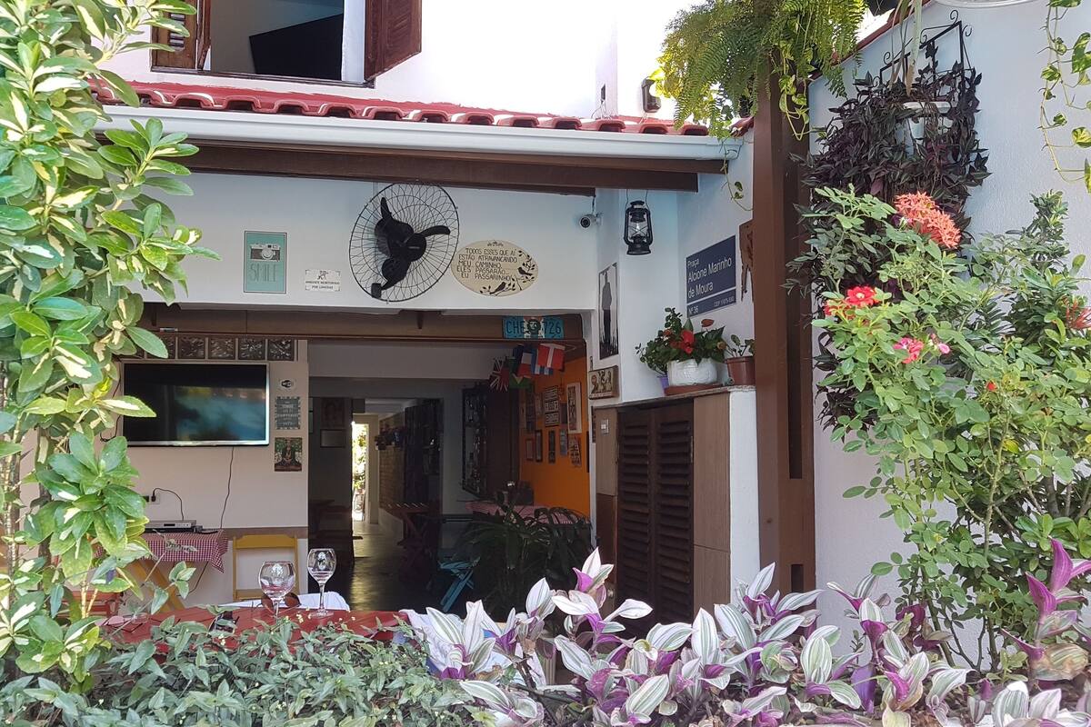 A building with a sign reading "SMILE" and a fan above the entrance.