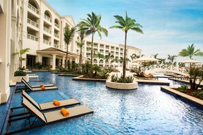 A hotel pool area with lounge chairs and palm trees. - Hyatt Zilara Rose Hall - Adults Only - All Inclusive (Montego Bay)