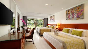 A hotel room with two beds, a desk, a TV, and a painting on the wall.