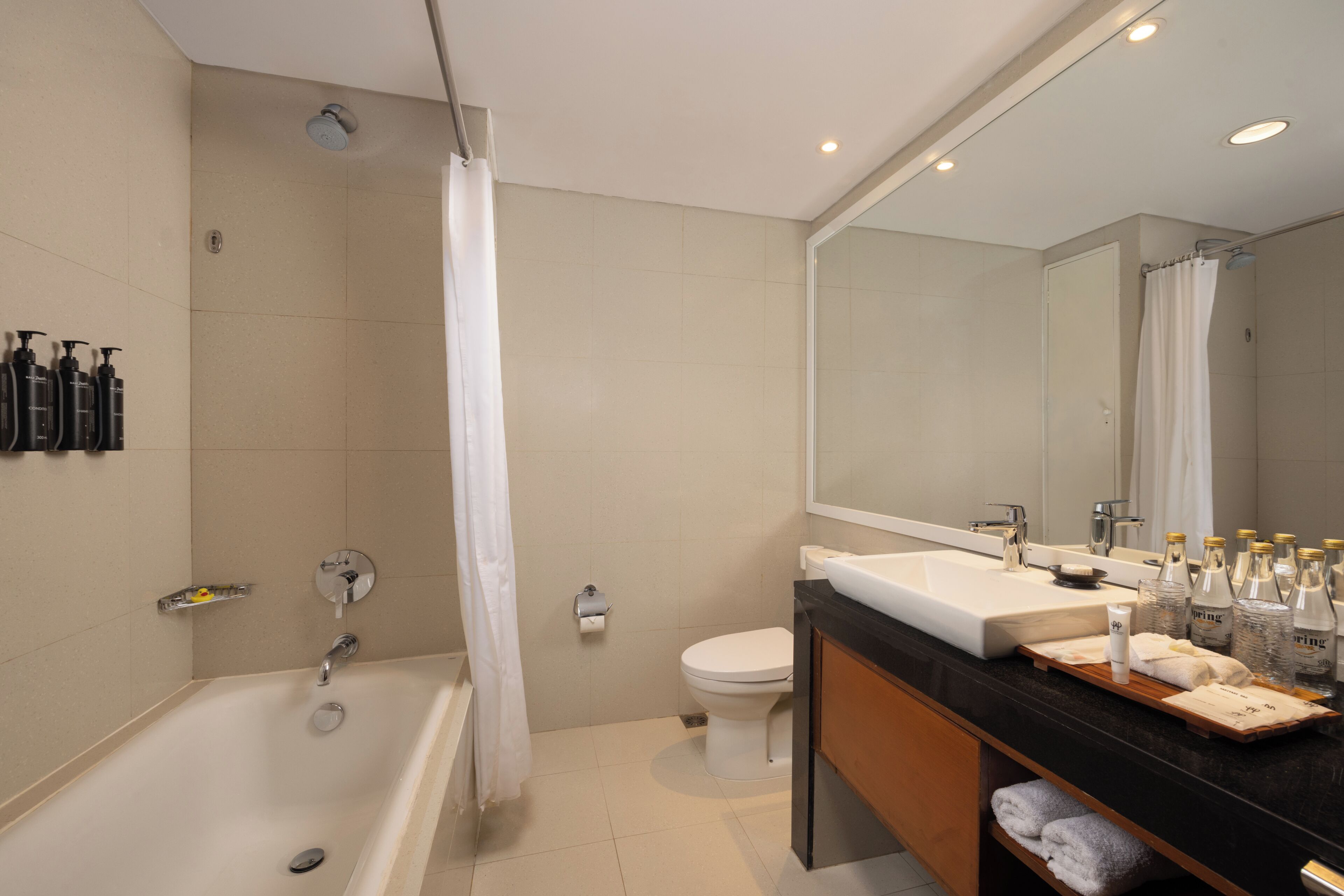 A modern bathroom with a bathtub, toilet, and sink.