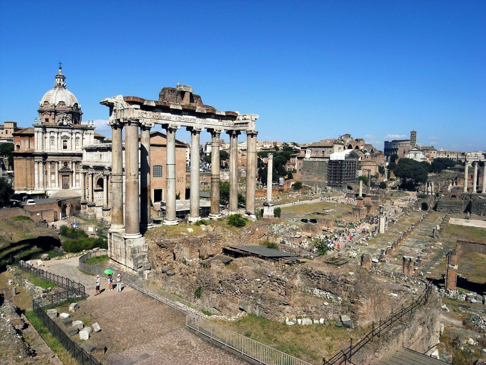 Ancient ruins with columns and a large dome structure.