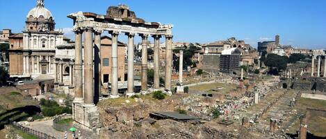 Ancient ruins with columns and a large dome structure.