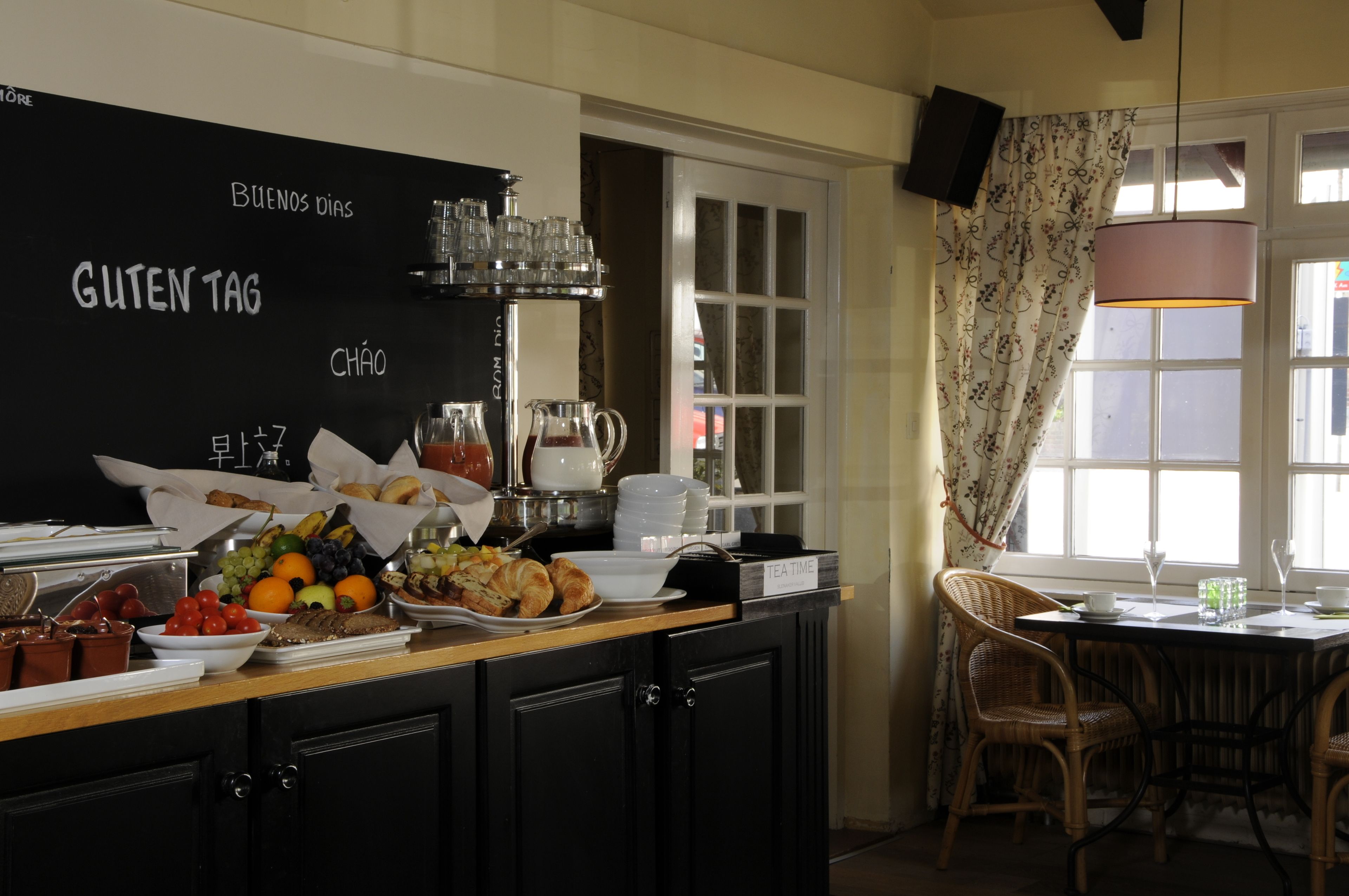 A breakfast buffet with various food items and a coffee station.