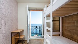 A balcony with a wooden floor and a view of the sea. - Hostel Link  (Lovran)