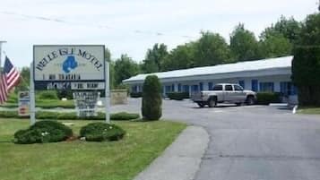 Simple, single-story motel with a grassy area and paved driveway.