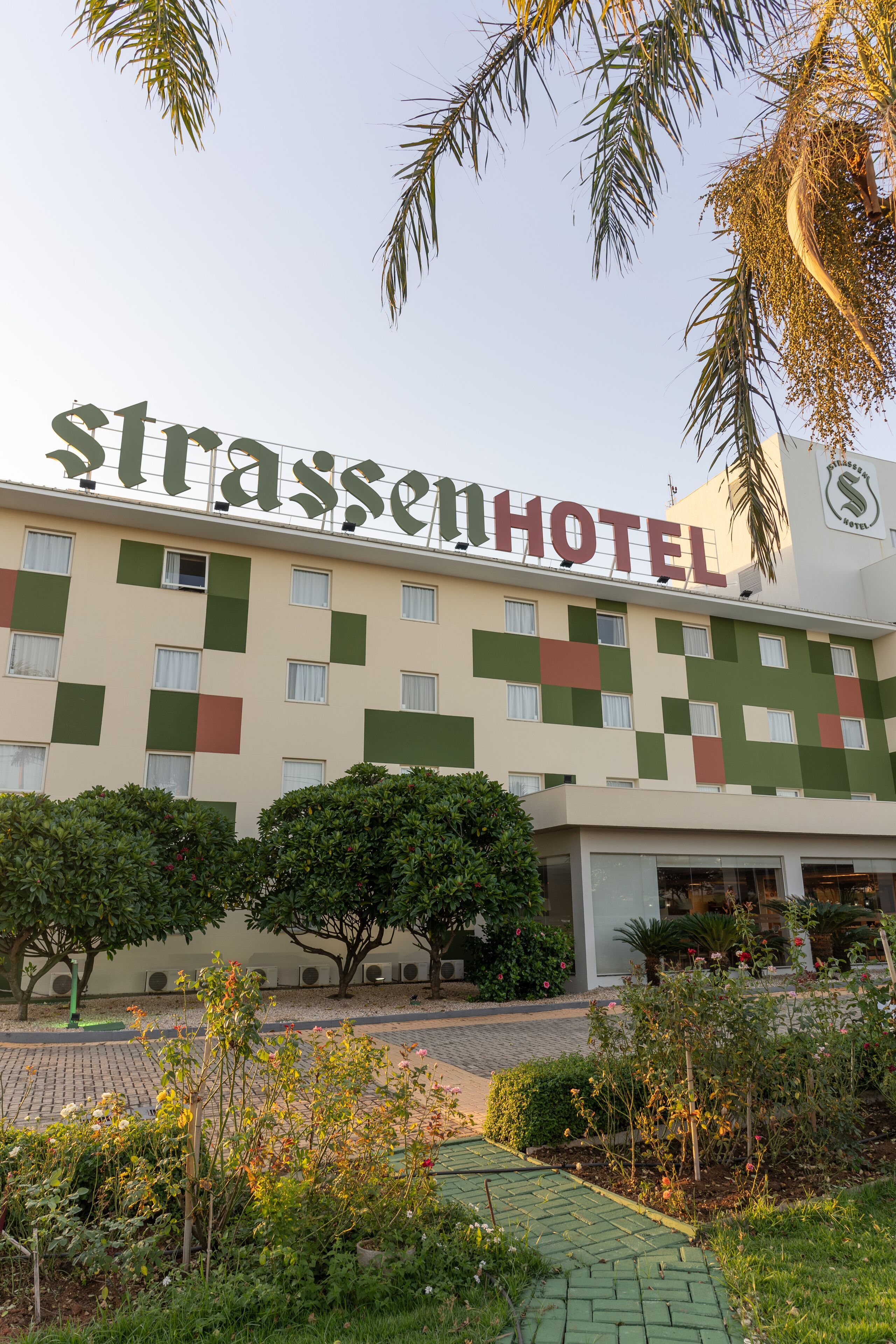 A hotel with a checkered facade and a sign reading "Strassen Hotel".