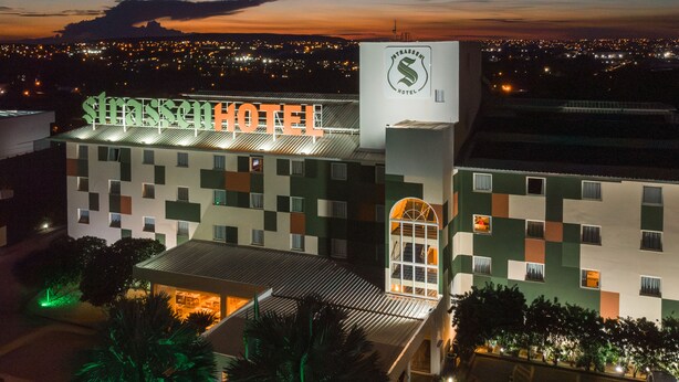 A hotel with a distinctive checkered facade and a prominent sign reading "Strasburg Hotel". -  Strassen Hotel (Aparecida de Goiania)