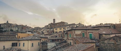A historic town with closely packed buildings, narrow streets, and a prominent tower.