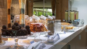 A buffet with various food items and a coffee station.