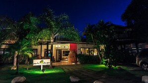 A hotel with a sign reading "Porto Zarpa Hotel" in a well-lit garden at night. - Porto Zarpa Hotel (Mata de São João)