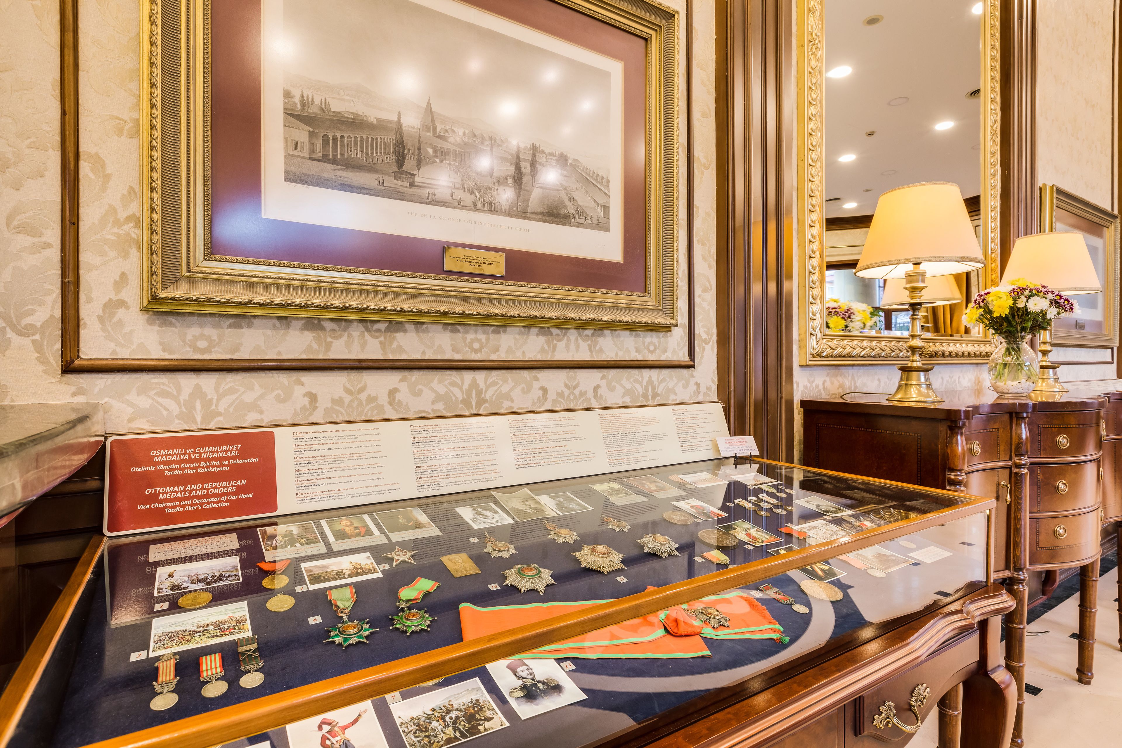 A display case with medals and a framed historical photograph.