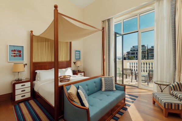 A four-poster bed with a canopy, a sofa, a chair, and a balcony with outdoor seating. - Regent Porto Montenegro (Tivat)