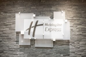 A Holiday Inn Express sign on a stone wall. - Holiday Inn Express & Suites Norman by IHG (Norman)