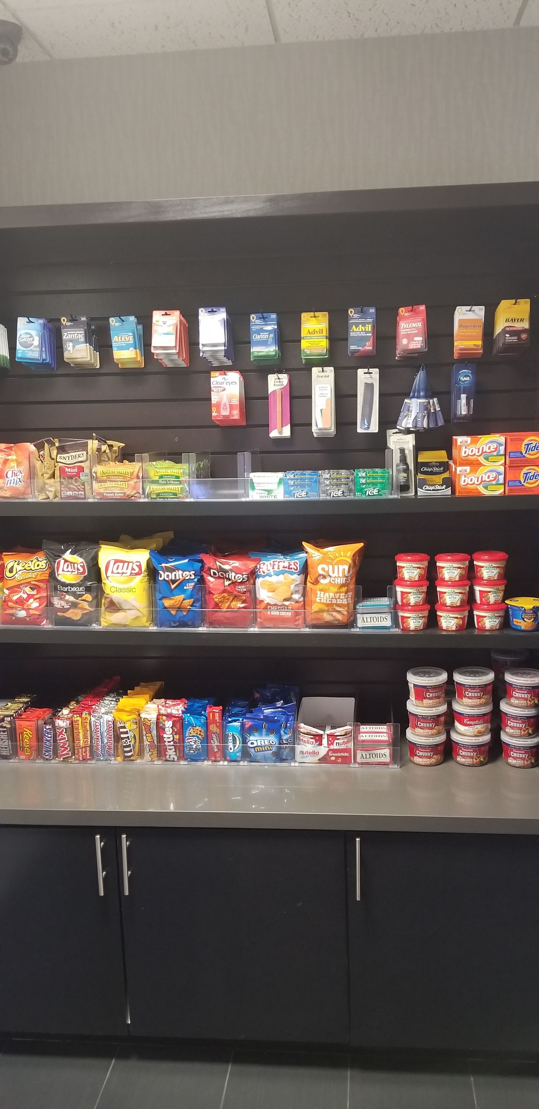 A snack display with various brands and types of chips, cookies, and other snacks.