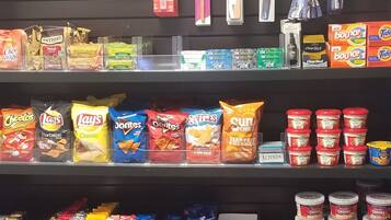 A snack display with various brands and types of chips, cookies, and other snacks.