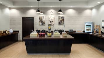 A modern kitchen with a central island, wooden countertops, and a variety of food items.