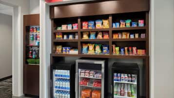 A snack and beverage vending area with various snacks and drinks.