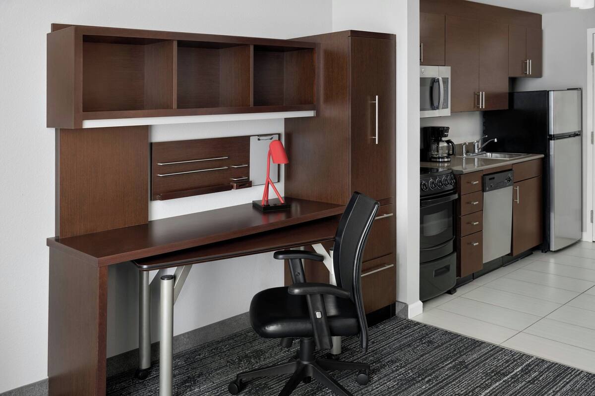 A modern kitchen with a built-in microwave, stove, and refrigerator.