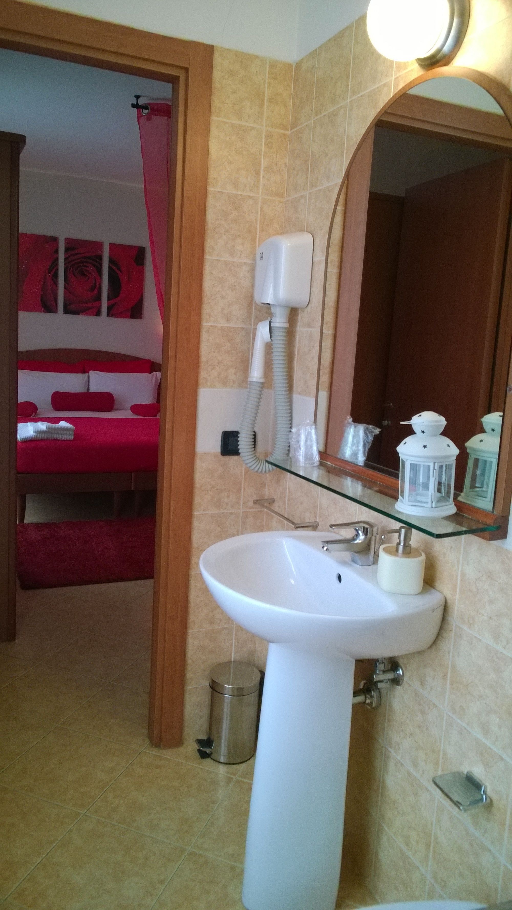 A bathroom with a white sink, mirror, and shower curtain.