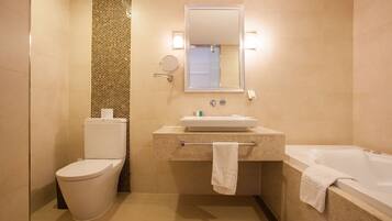 A bathroom with a toilet, sink, and bathtub.