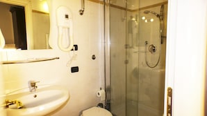 A bathroom with a sink, toilet, and glass-enclosed shower. - Sixtythree Guesthouse (Rome)