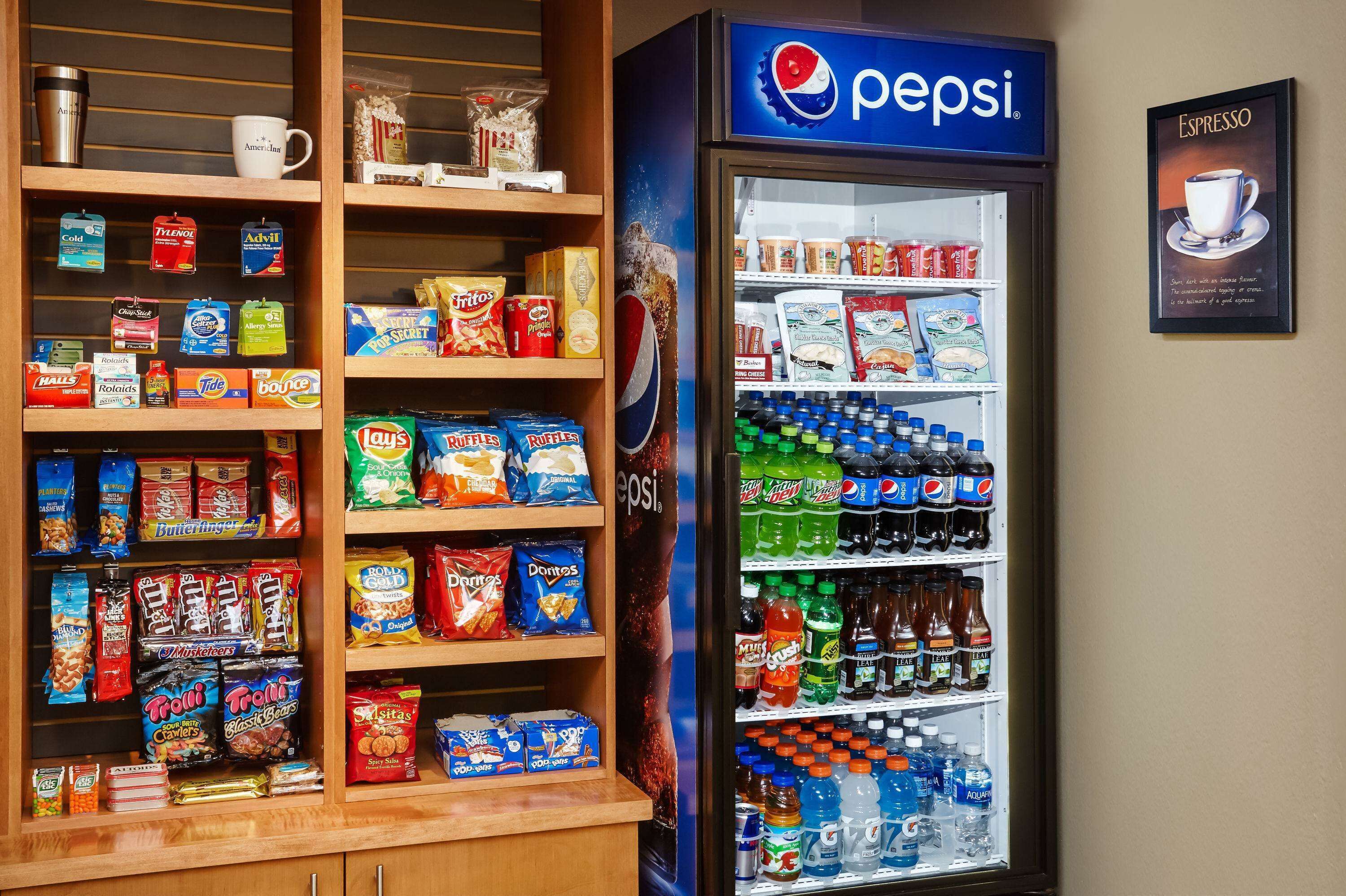 A vending machine stocked with snacks and beverages, including Pepsi products.