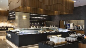 A modern kitchen with a central island, built-in appliances, and a variety of food and drink dispensers. - LOTTE CITY HOTEL GURO (Seoul)