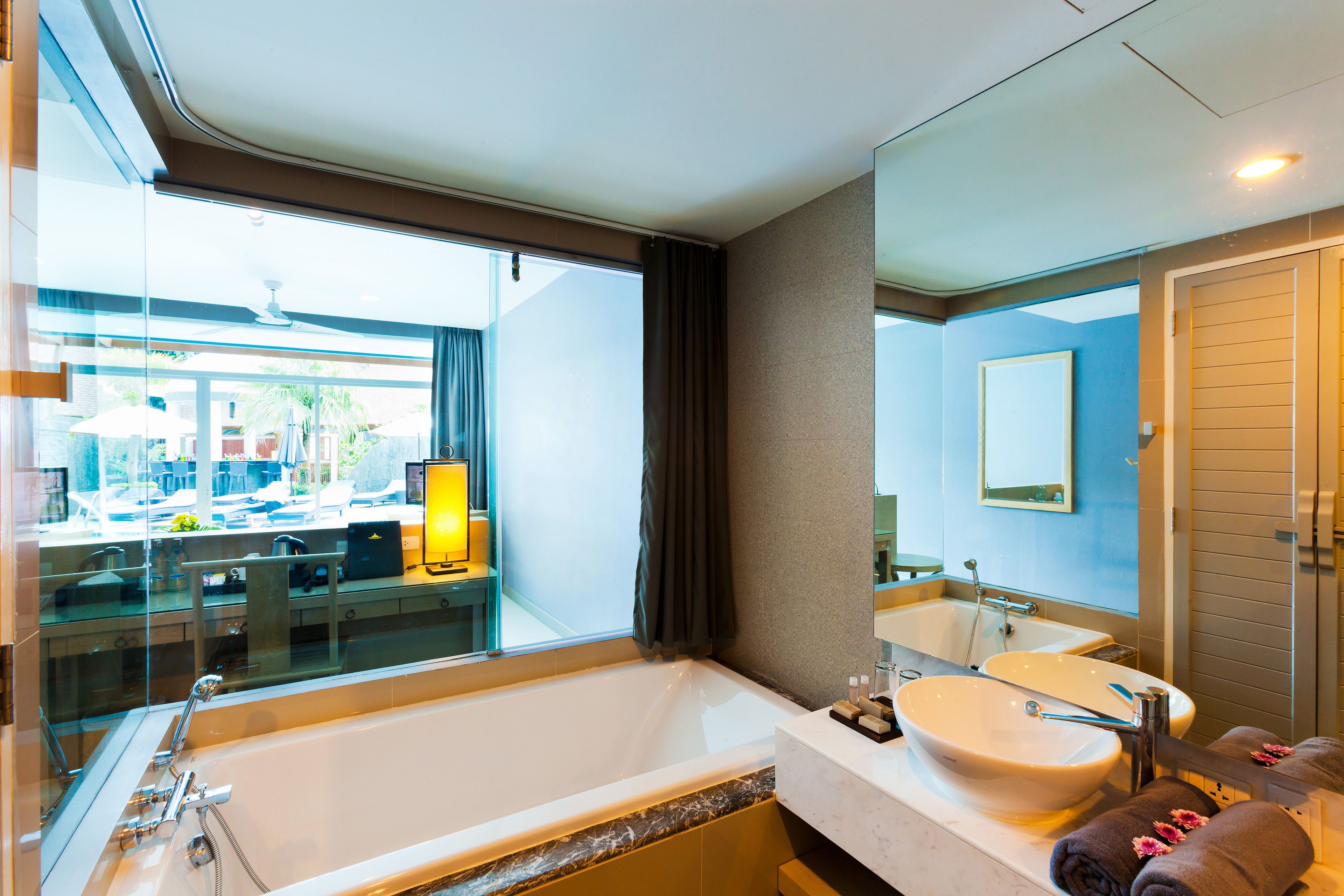 deluxe room (pool access) | bathroom | combined shower/bathtub, deep-soaking bathtub, free toiletries