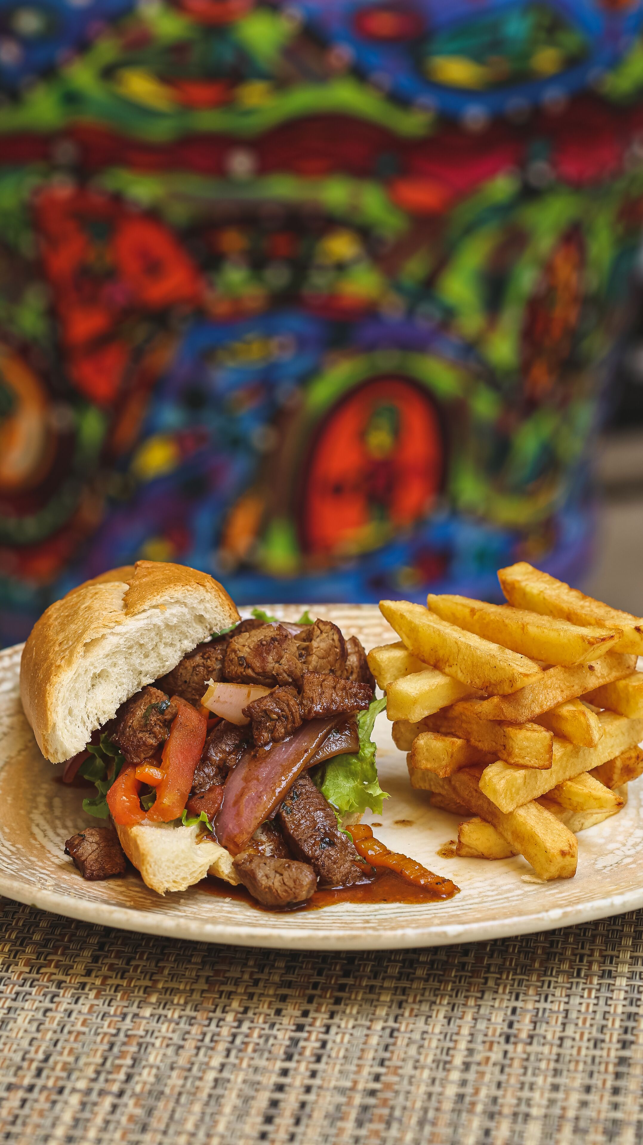 A plate with a sandwich and fries.