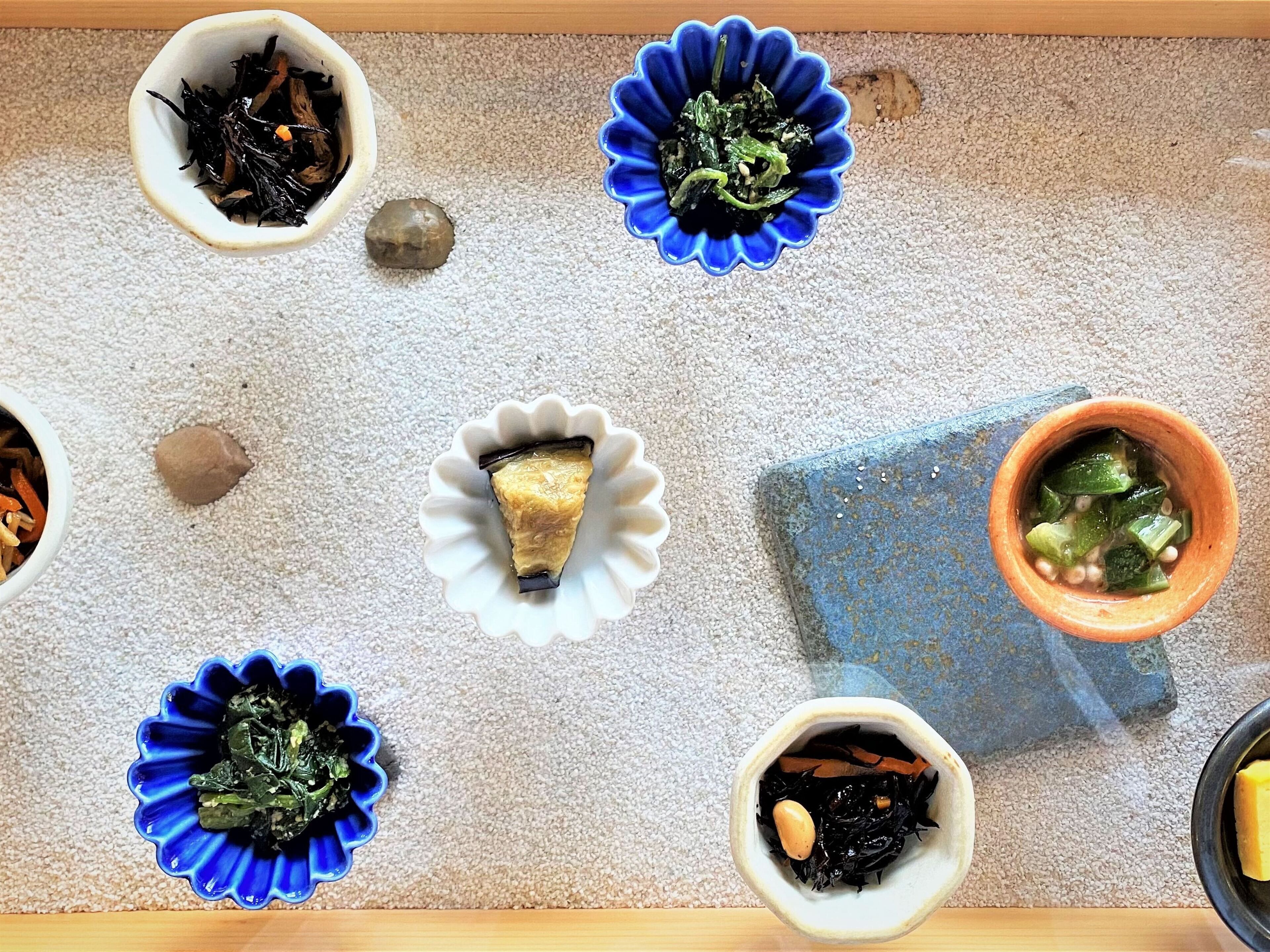 A dining table with various dishes and bowls.