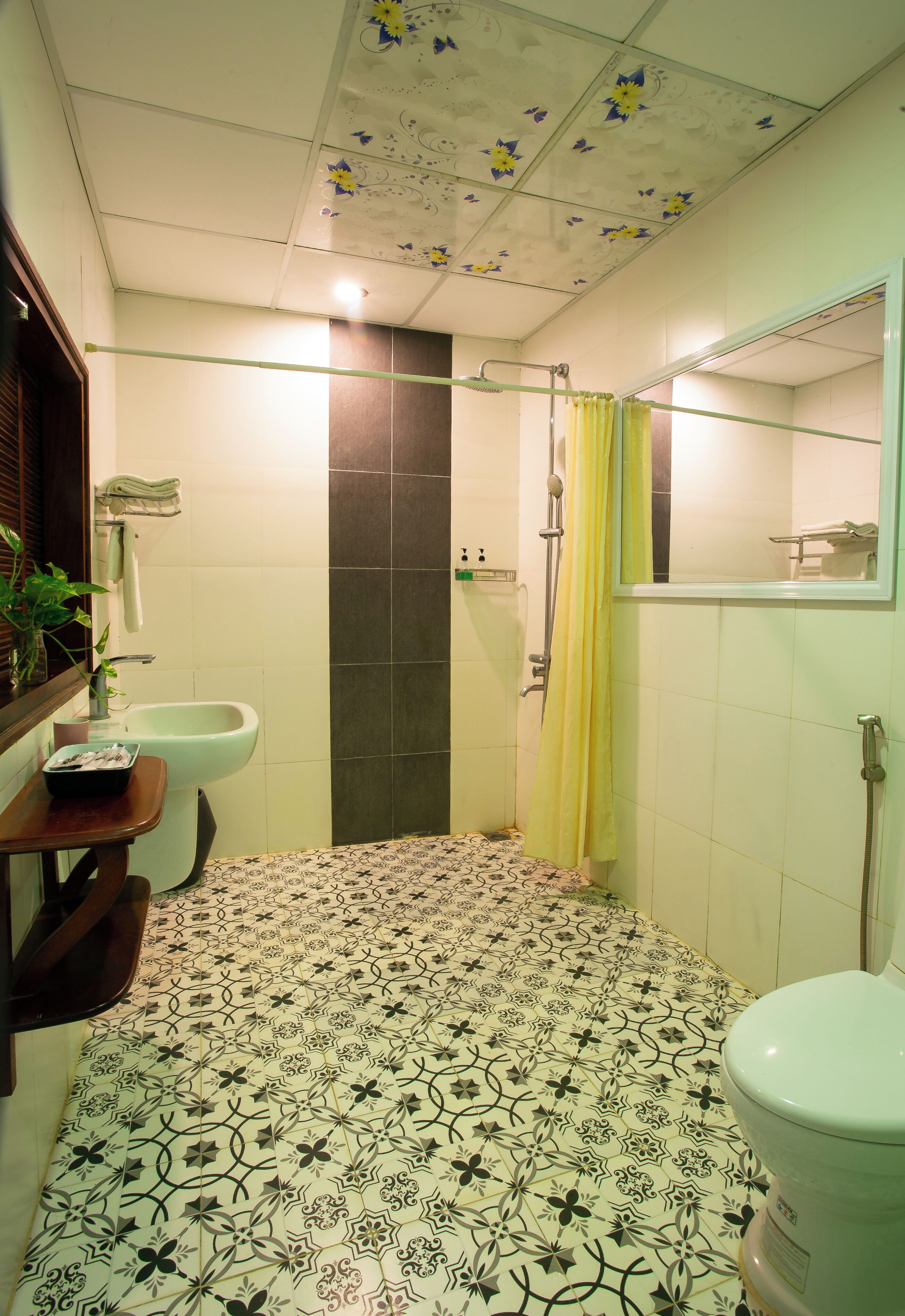 A bathroom with a shower, toilet, and sink.