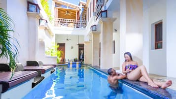 Outdoor pool, open 8 AM to 10:00 PM, pool umbrellas, pool loungers