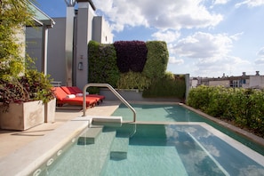 Seasonal outdoor pool, open 9:00 AM to 9:00 PM, pool loungers