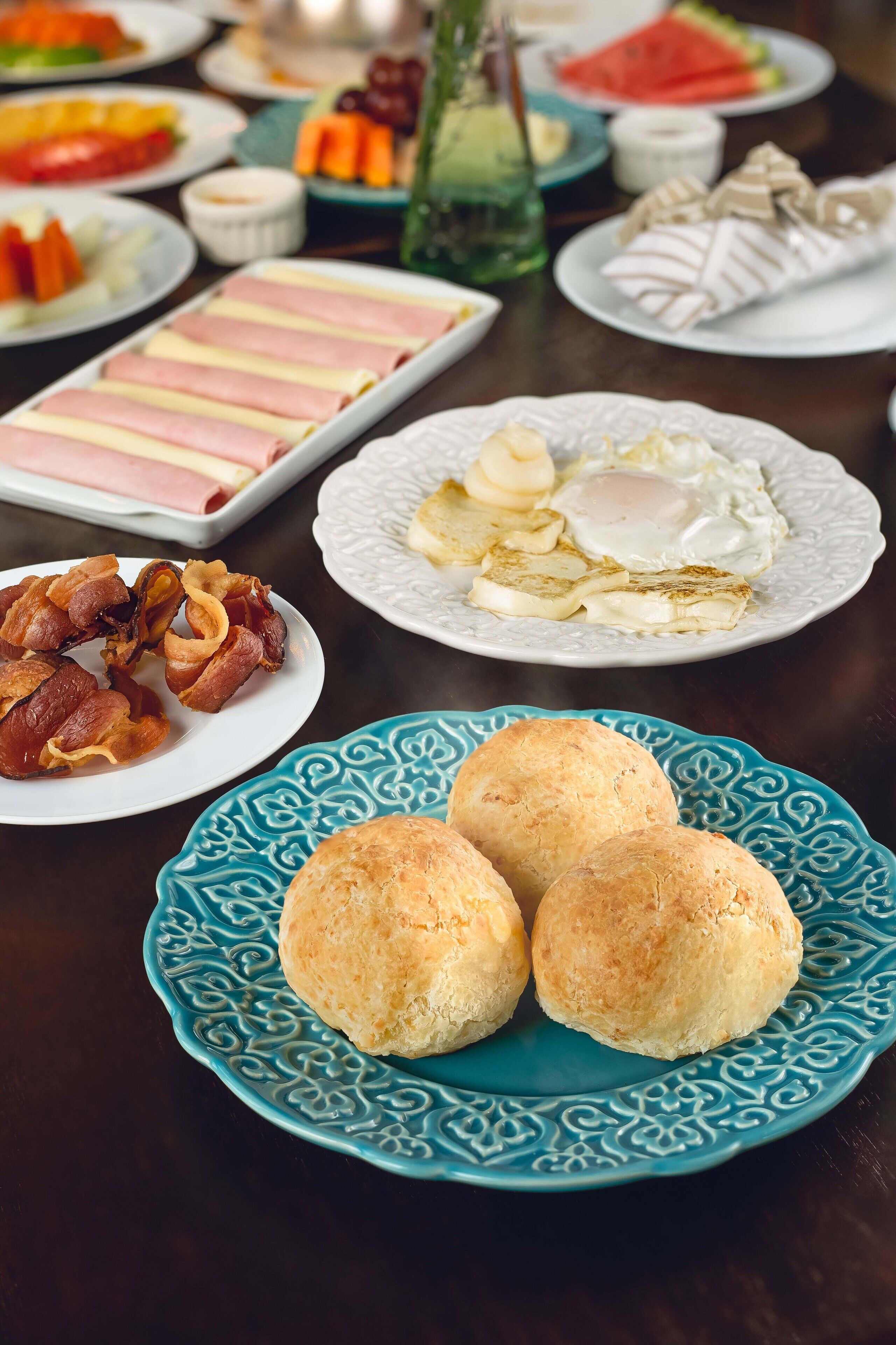 A breakfast spread with various foods including eggs, bacon, and pastries.