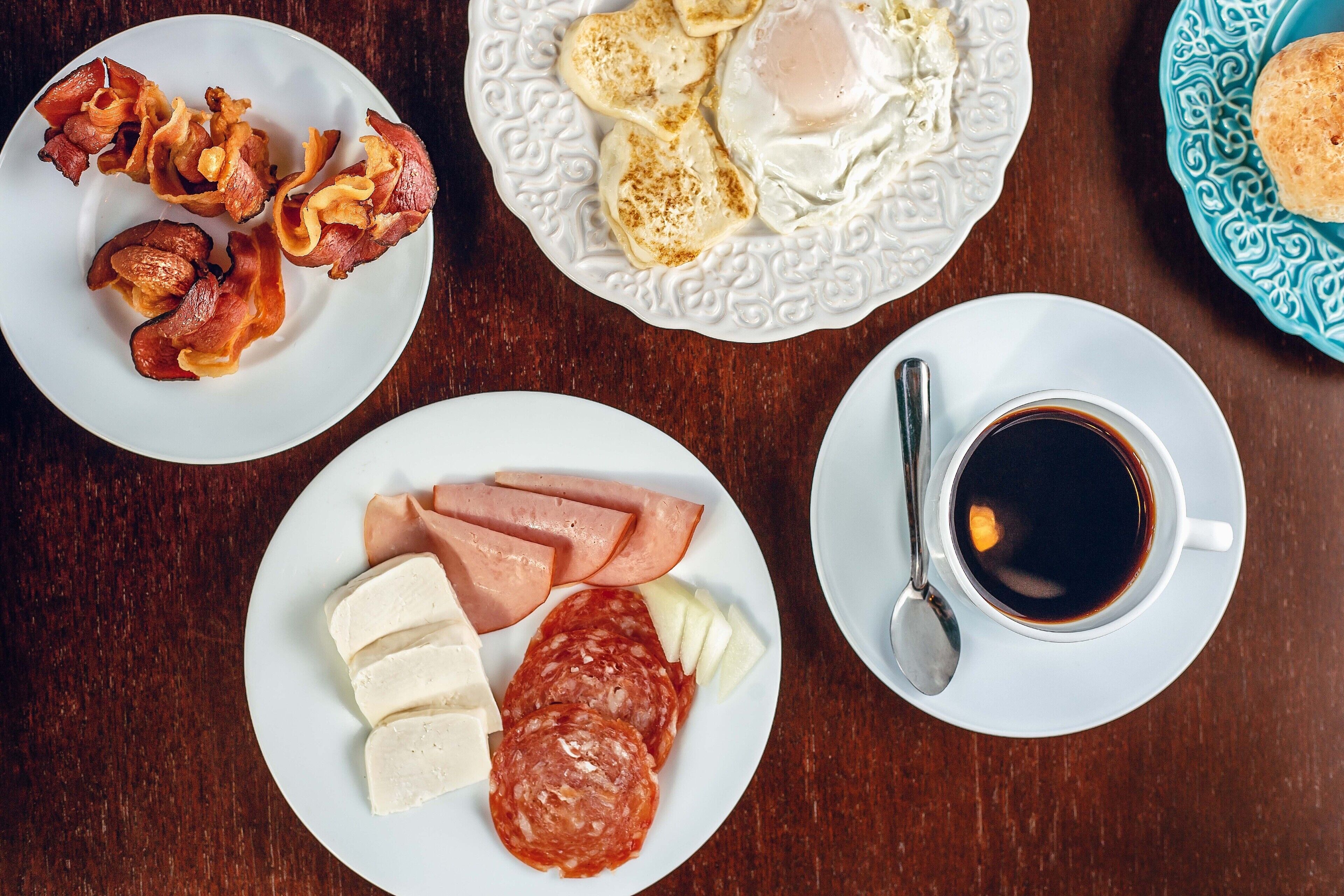 A breakfast plate with bacon, eggs, and ham.