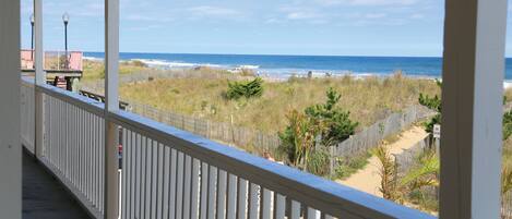 Ein Balkon mit Blick auf Strand und Meer.