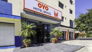 A hotel named OYO Hotel Brazil with a signboard, entrance, and potted plants. - OYO Hotel Brazil,Guadalajara,Estadio Jalisco (Guadalajara)