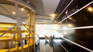 A modern interior with a black wall and a sign reading "LOUNGE". - Borneo Royale Hotel (Tawau)