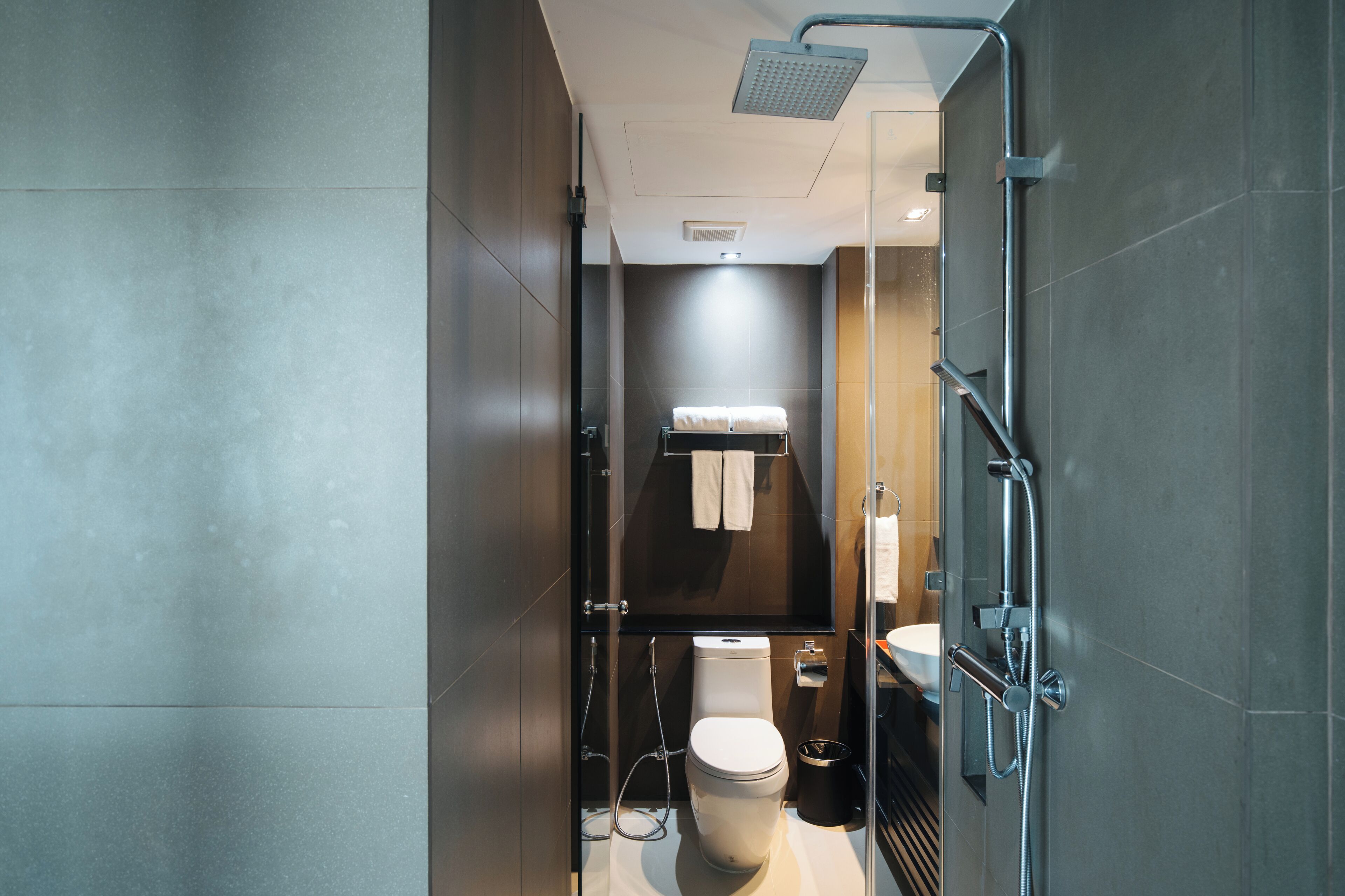 A modern bathroom with a toilet, bidet, and shower.